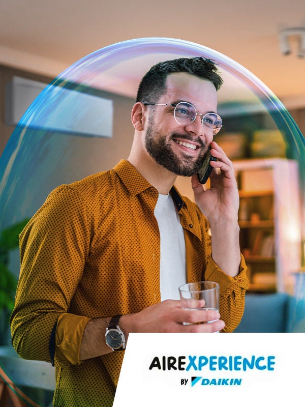 Hombre sonriendo al teléfono en un ambiente perfectamente climatizado