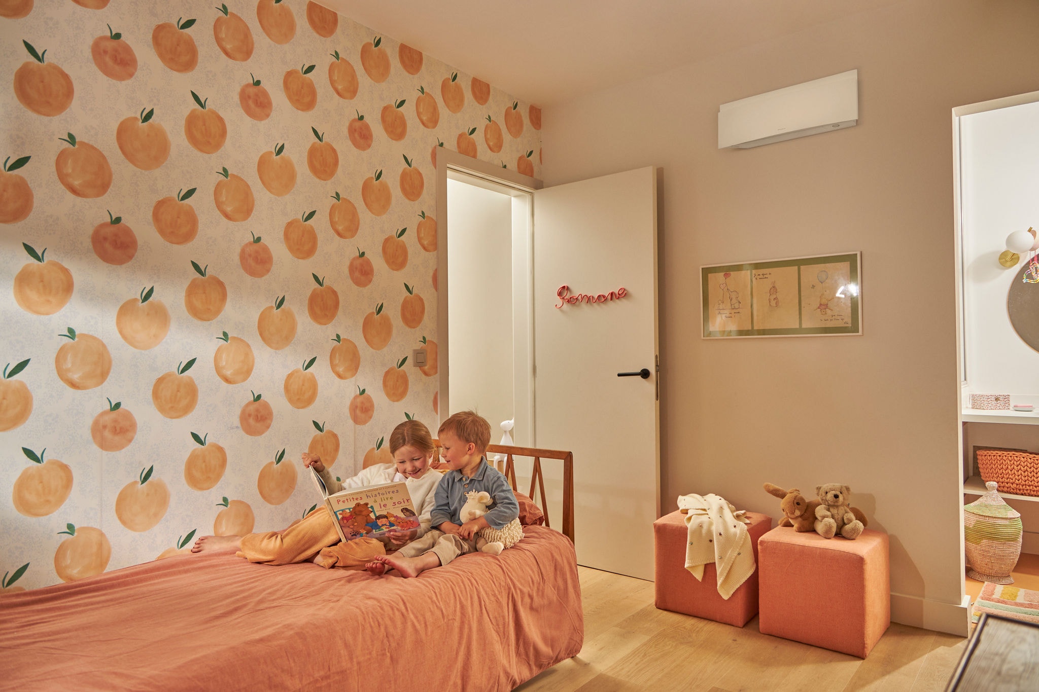 Niños jugando en la cama con una temepratura agradable gracias al modo sleep del aire acondicionado