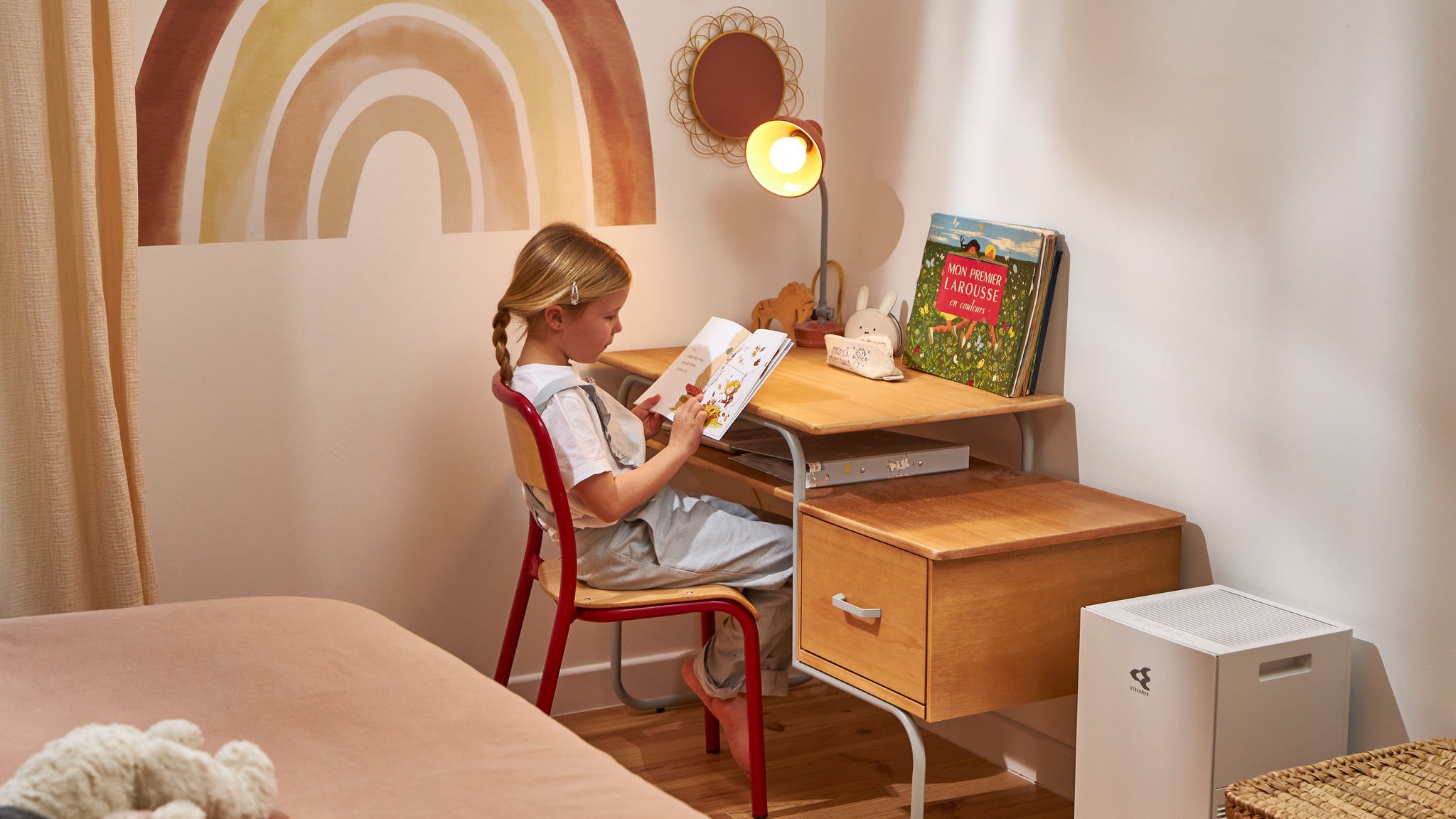 Child reading in her room with clean air