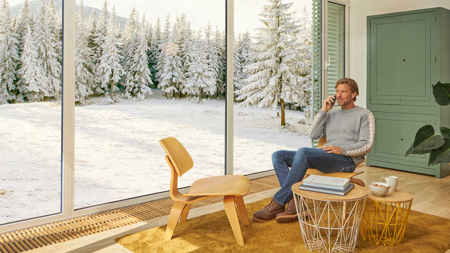 Hombre hablando por el móvil en la sala de su casa