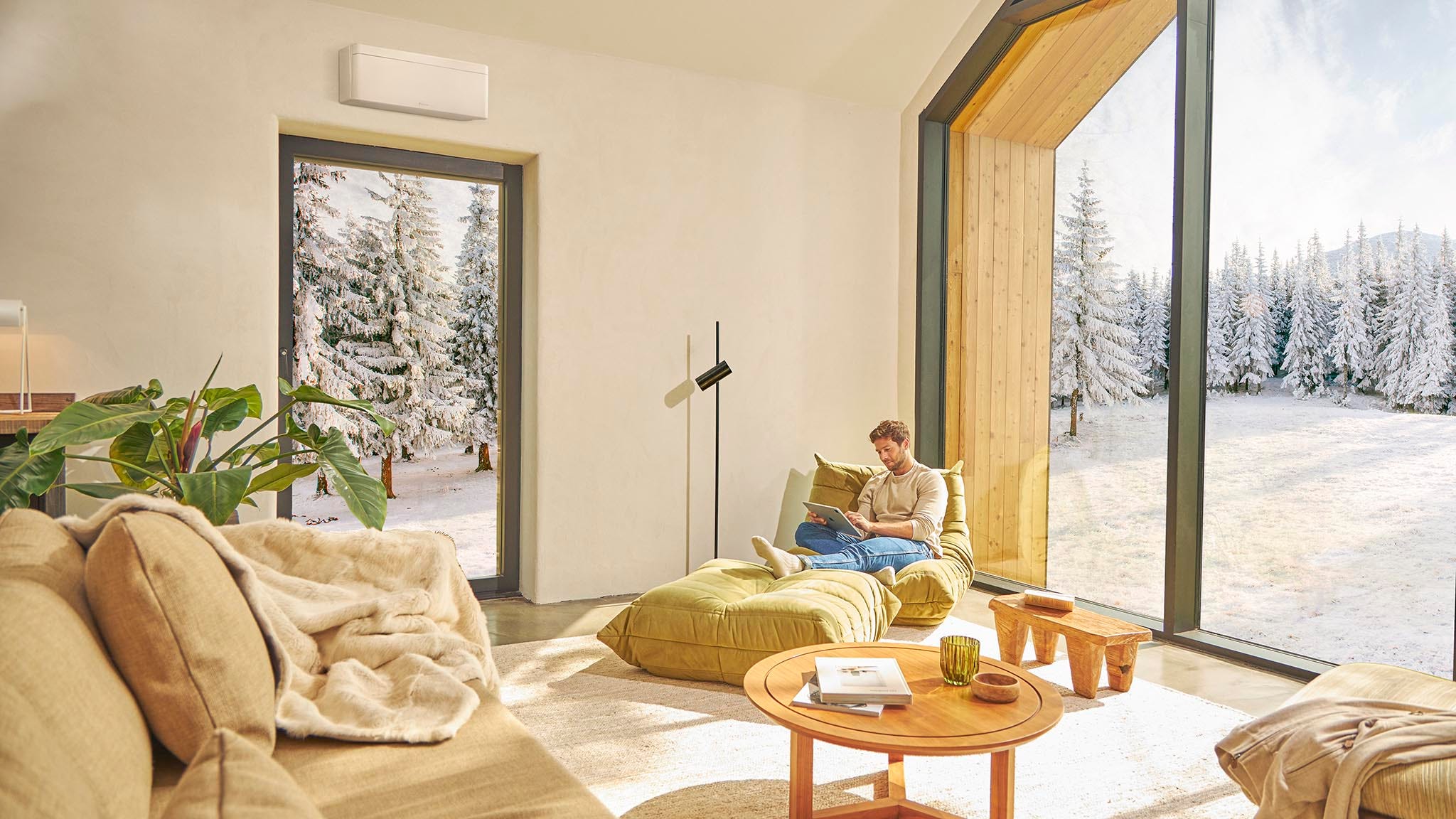 Man sitting on the sofa and enjoying the air conditioning heating