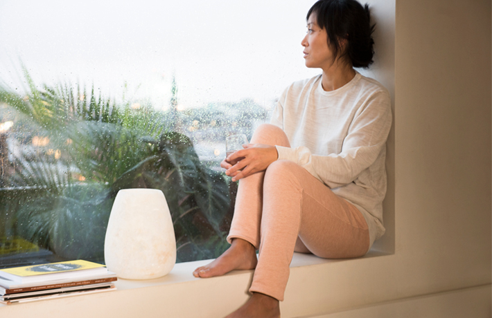 Woman looking outside a window